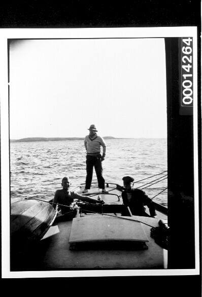 Men at the stern of yacht UTIEKAH II at sea