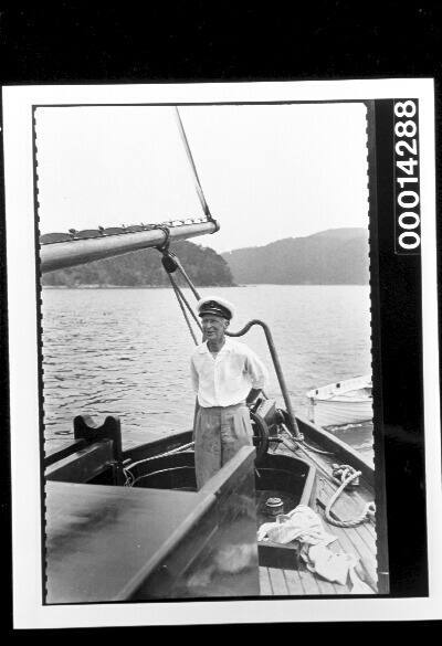 Harold Nossiter Snr in the cockpit of yacht SIRIUS