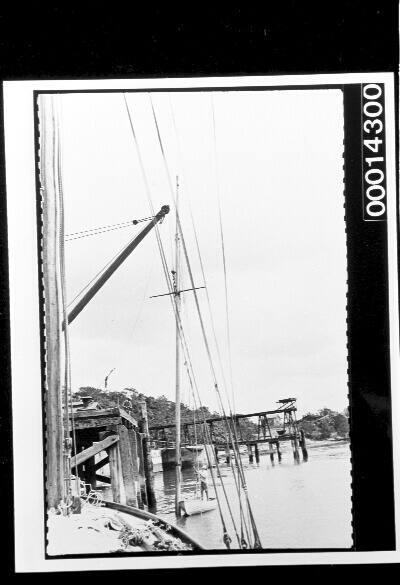 Wharf crane lifting a mast