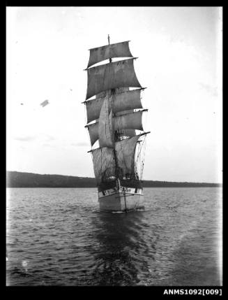 A bow-on view of the square-rigged ship RAUPO (ex LOUISA CRAIG) with sails set and underway