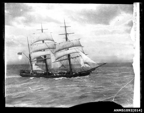 Three-masted barque underway with reduced sail