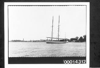 Port side view of yacht moored with sails furled