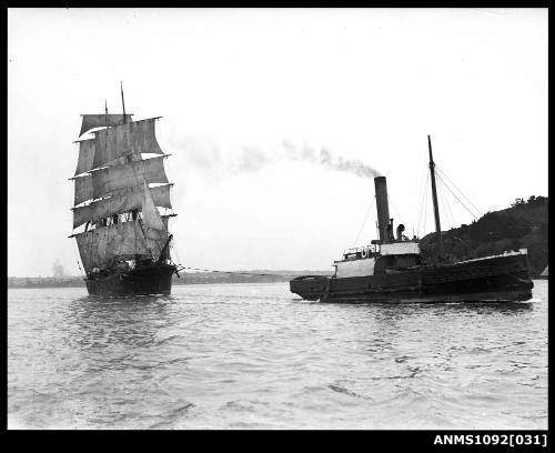 Three-masted barque, possibly NOTERO, being towed out to sea by a tug