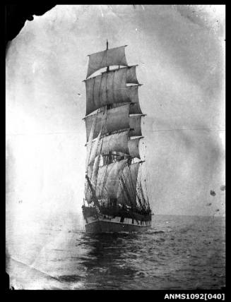 Bow-portside view of a three-masted barque with sails set