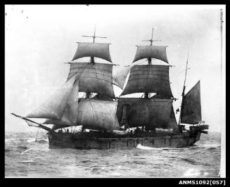 Three-masted barque with sails set and underway