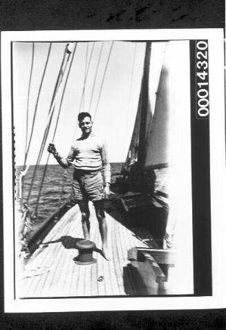 Young man standing on the deck of yacht SIRIUS at sea