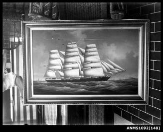 Ship portrait resting upside down on a cane chair