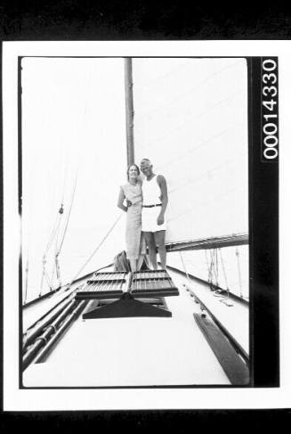 Young couple standing on the deck of a yacht