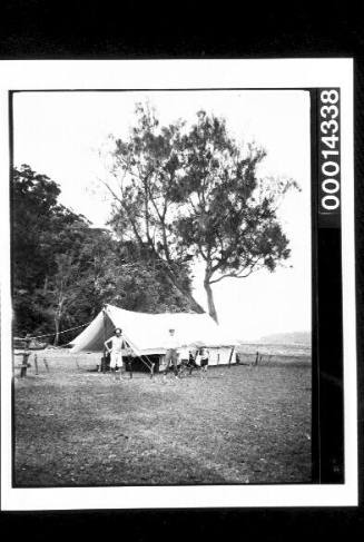 Large canvas tent on grass close to the waters edge