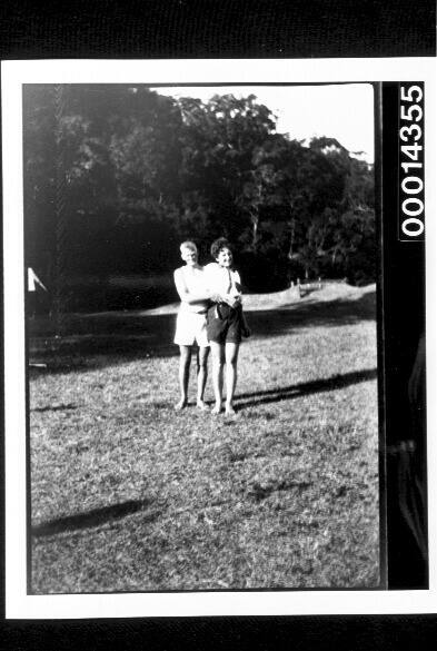 Young man and woman standing on a grassy clearing