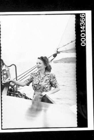 Young woman standing at the stern of yacht SIRIUS