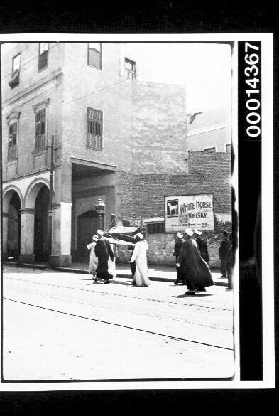 Funeral procession along a middle eastern street