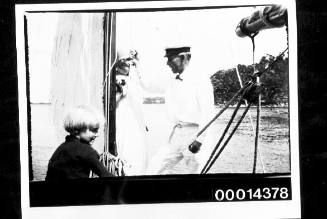 A woman, man and young boy on the deck of a yacht