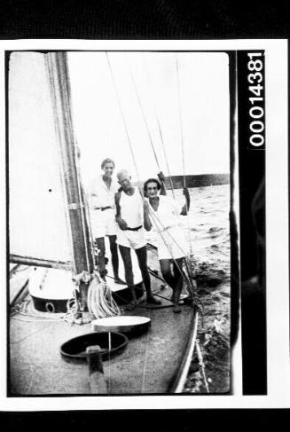 Two women and a young man on the deck of a yacht at sea