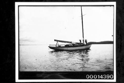 Single masted yacht moored just off land