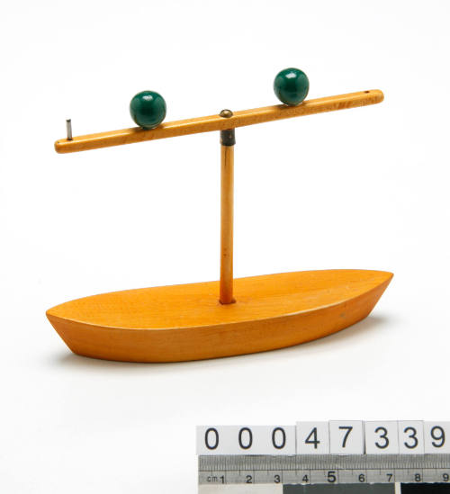 Model boat with two green balls from navigation lights and buoys examination kit 00047331