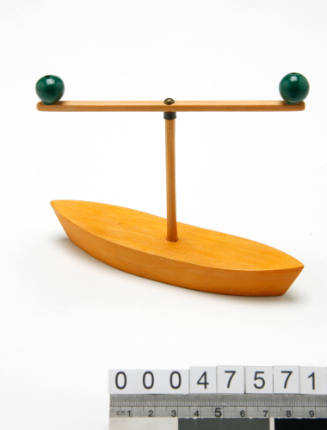 Miniature wooden boat a mast with two green balls