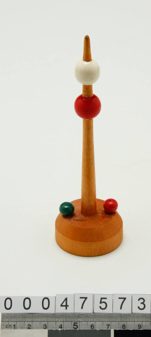 Wooden buoy with red and white balls