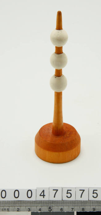 Wooden buoy with three white balls