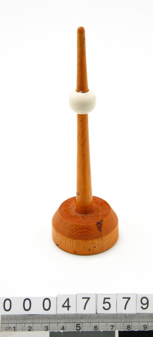 Wooden buoy with a white ball