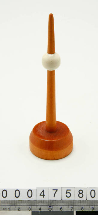 Wooden buoy with a white ball