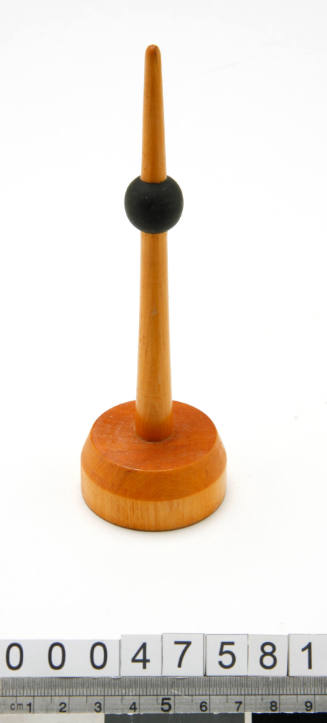 Wooden buoy with a black ball