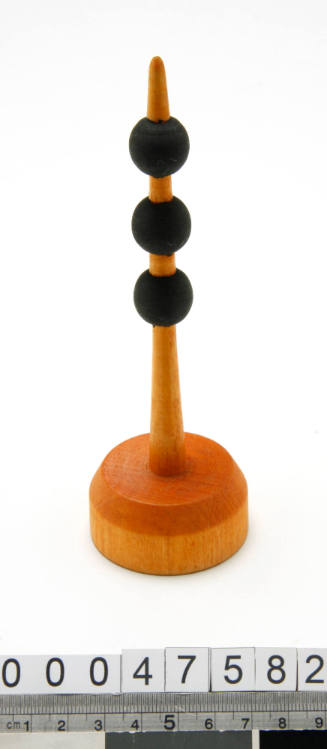 Wooden buoy with three black balls