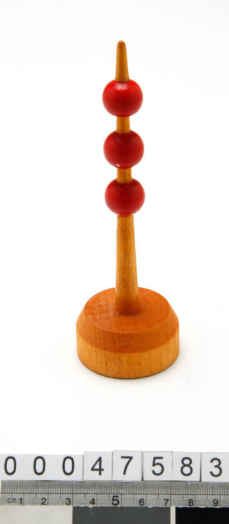 Wooden buoy with three red balls