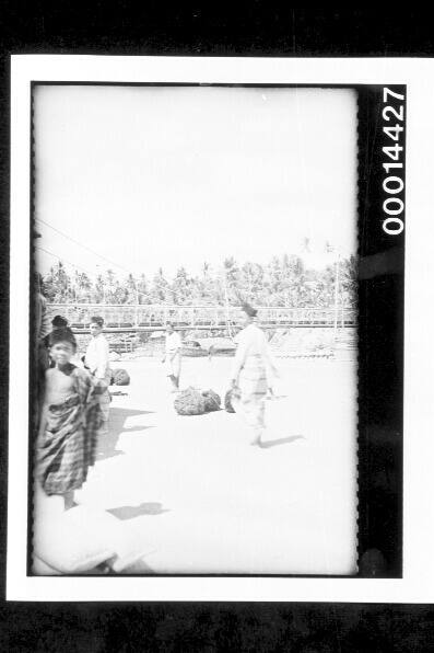 People along the busy foreshore of Buton Port, Indonesia