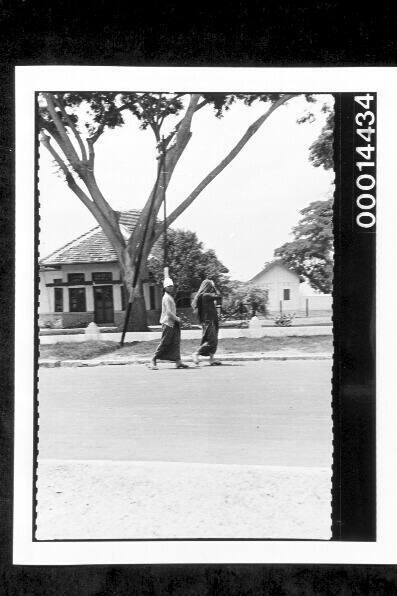 Women walking along a street at Buton, Indonesia