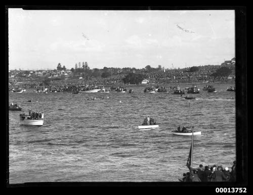 Coxed rowing fours racing before a large spectator crowd in Sydney