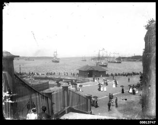 Spectators on the Man-o'-War steps watch a squadron in Farm Cove