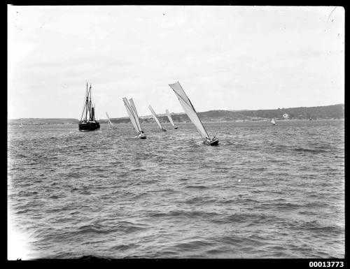 Five sloops racing past a steamboat