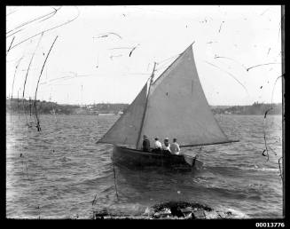 Skiff sailing on Sydney Harbour, Watsons Bay in the background