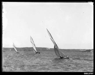 Three yachts racing on Sydney Harbour