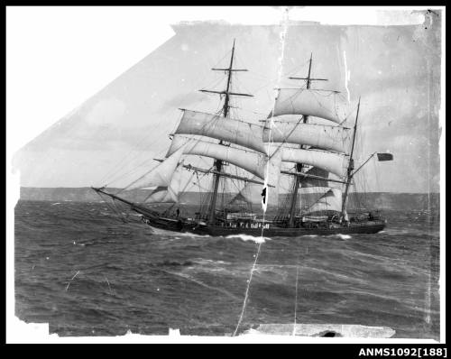 Negative of a three masted barque underway with reduced sail