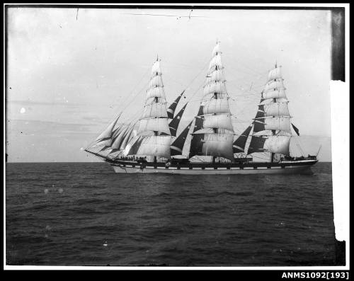 Portside view of three masted full rigged ship underway