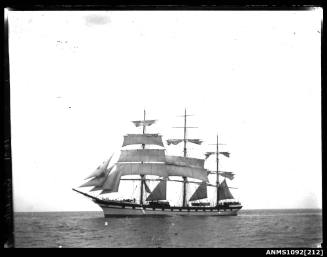 A three masted full rigged ship with reduced sail