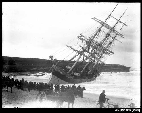 Three masted full rigged ship aground lying on her portside