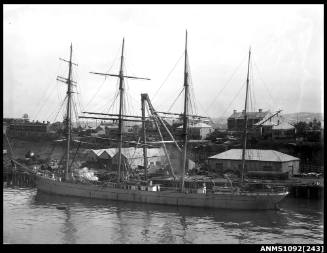 Negative of four masted barque BENCAIRN moored alongside wharf