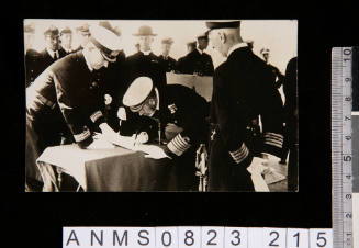 George V signing a document on his visit to HMAS AUSTRALIA on 17 July 1928