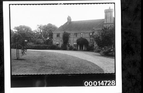 The front lawn and driveway of a large house in England