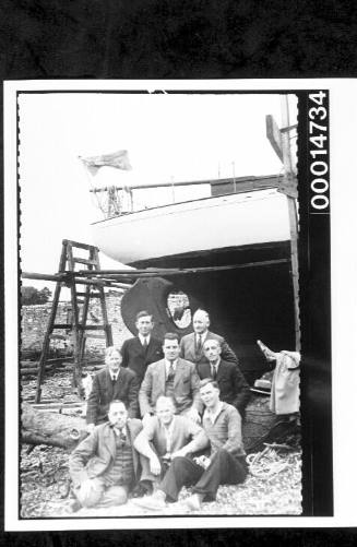 The Nossiters with shipyard employees in front of the yacht SIRIUS on slips at Cremyll, England