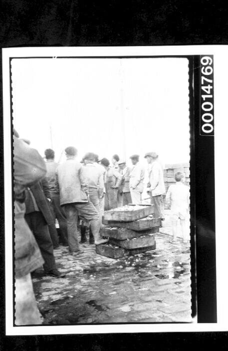 Stacked crates of fish on a crowded wharf in Algeciras, Spain