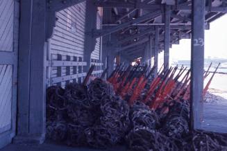 Slide depicting neatly stacked equipment at the wharf