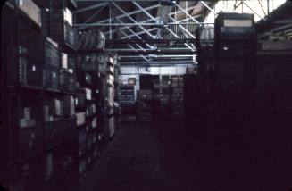 A coloured slide depicting the inside of a warehouse