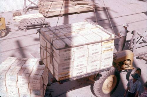 Slide depicting neatly stacked wooden crates on a tractor