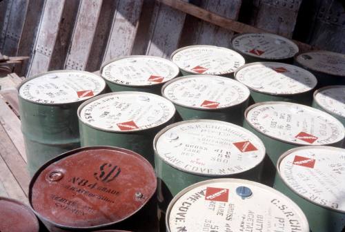 Slide depicting CSR Chemical drums stacked up together on a wharf