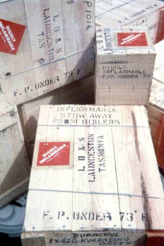 Slide depicting wooden crate stamped with inflammable stow away from boilers