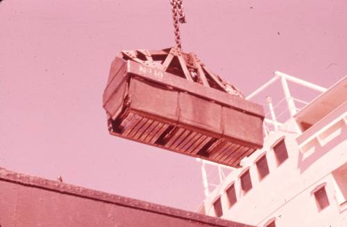 Slide depicting cargo bring hoisted onboard a ship